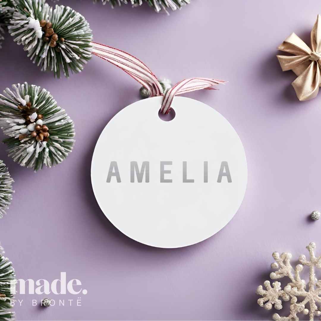 white bauble with silver font in bold capitals - amelia. made by bronte